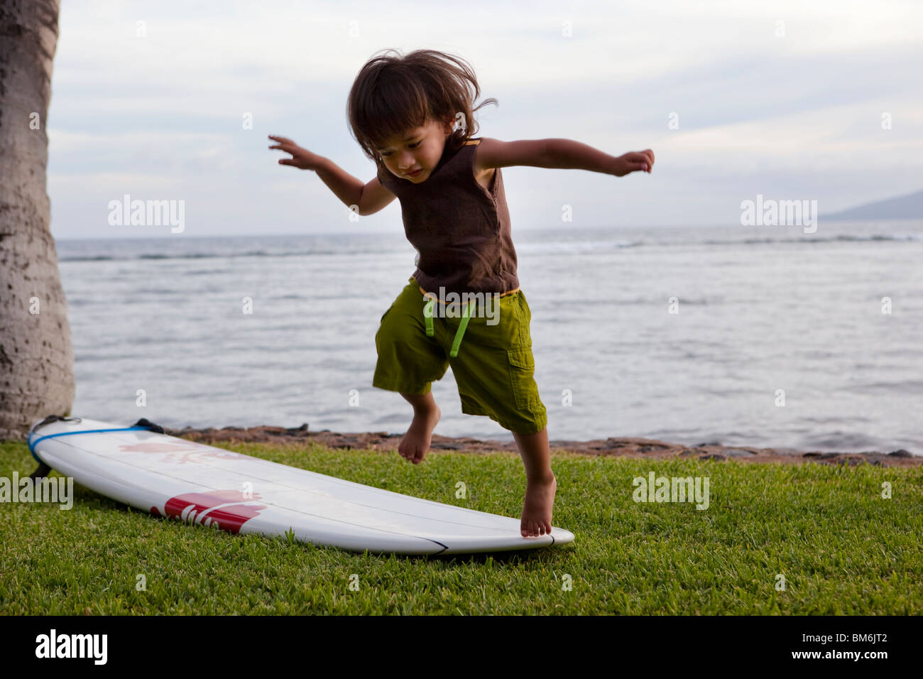 Garçon sautant hors de surf Banque D'Images