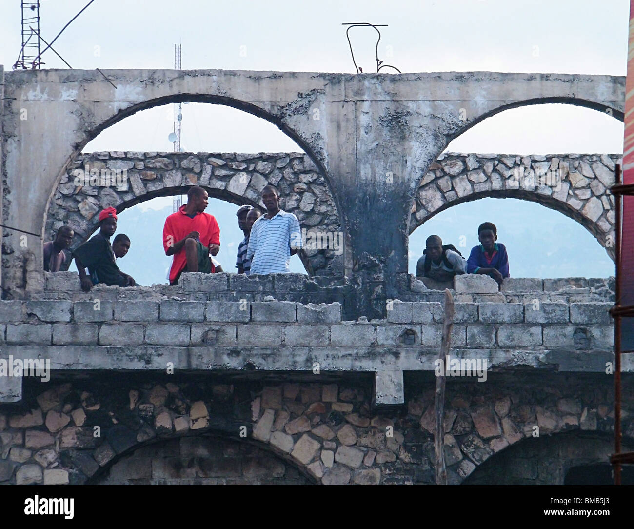 Hommes, l'air à l'extérieur d'un bâtiment endommagé à Port-au-Prince après le séisme en Haïti Banque D'Images