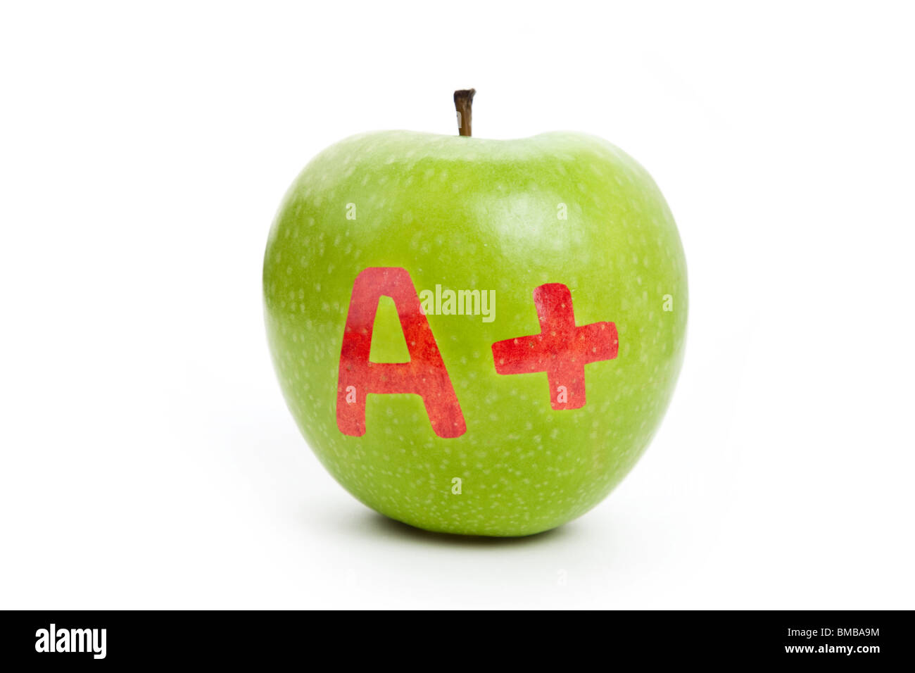 La pomme verte et un signe plus, Concept de l'apprentissage Banque D'Images