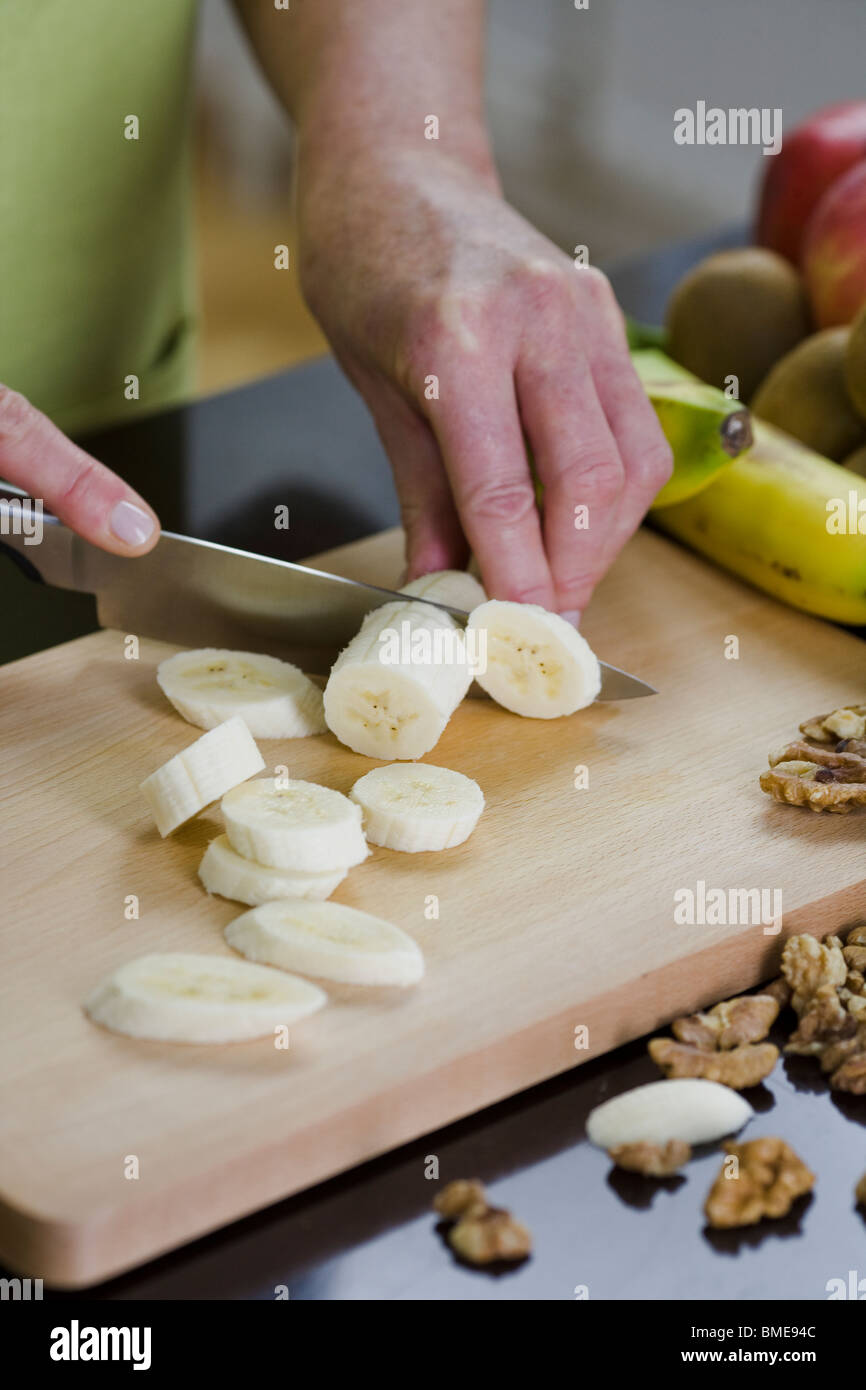 Femme faisant une salade de fruits, en Suède. Banque D'Images