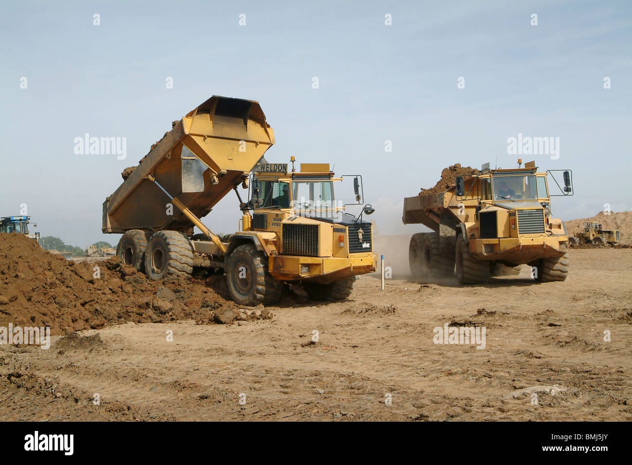 Les camions-benne Volvo travaille sur un chantier en Angleterre. Banque D'Images