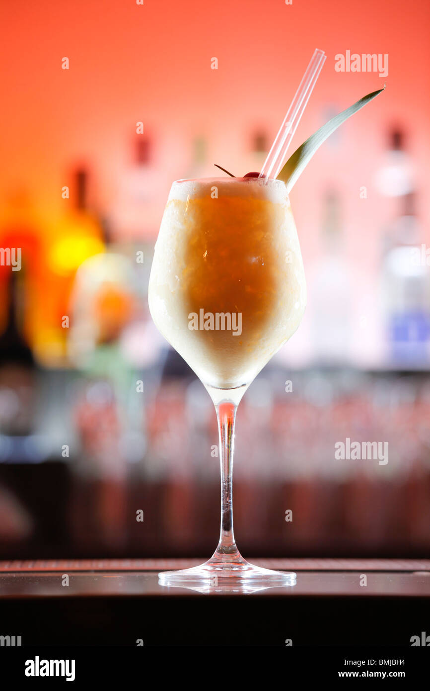 Pina Colada cocktail sur un bar, orange et fond rose Banque D'Images