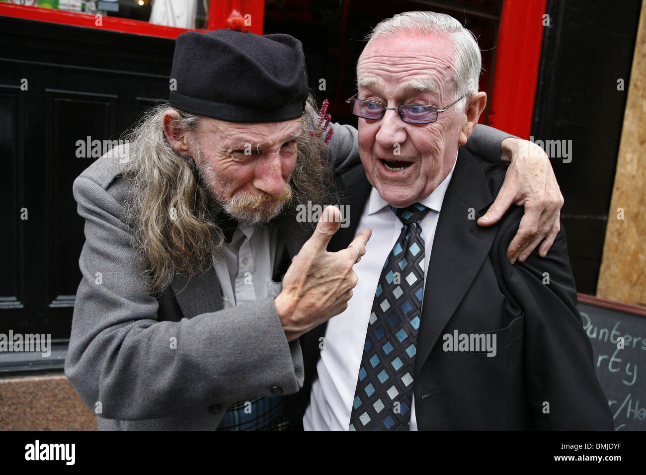 Deux amis à l'extérieur d'un pub, Glasgow, Ecosse Banque D'Images