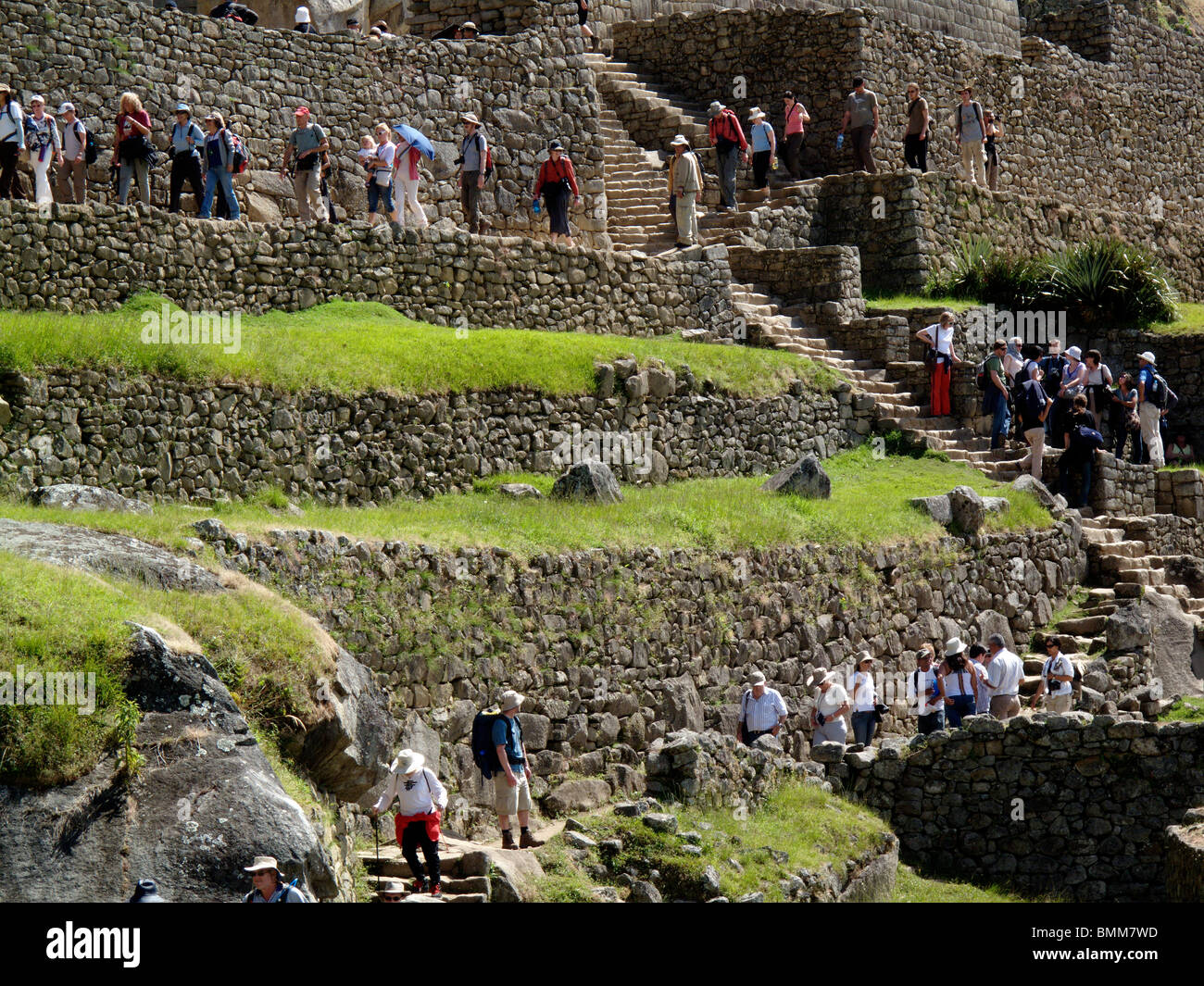 La foule des visiteurs de les anciennes ruines de Machu Picchu près de Cusco au Pérou à pied à travers le site Banque D'Images