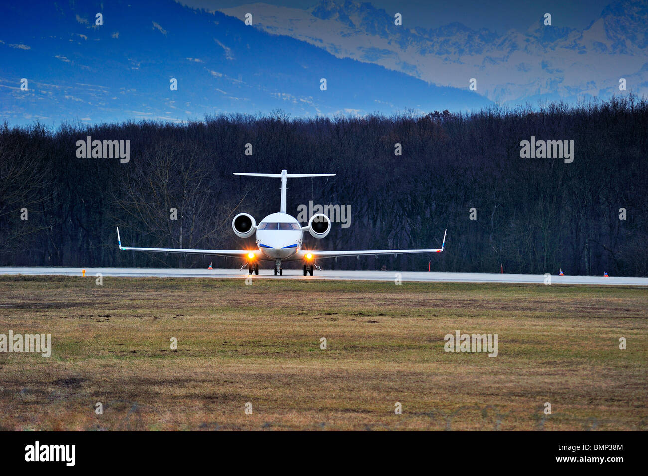 Prêt pour le décollage - un avion de l'alignement pour le décollage dans un paysage hivernal. Alpes enneigées en arrière-plan. Banque D'Images