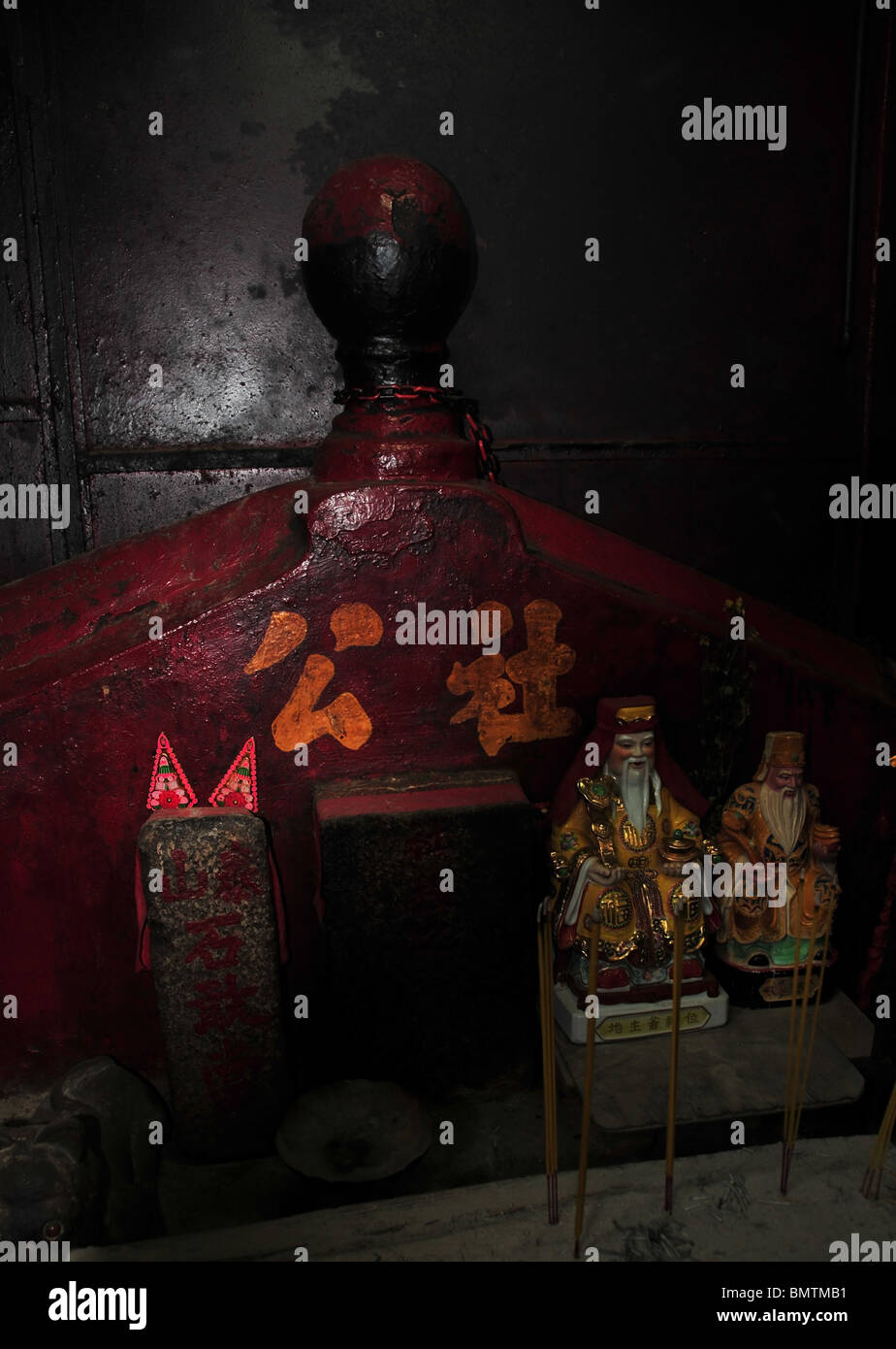Deux figurines taoïste barbu blanc debout devant un autel rouge dans une sombre salle de méditation. Pak chanter, Hong Kong Hall Ancestral Banque D'Images