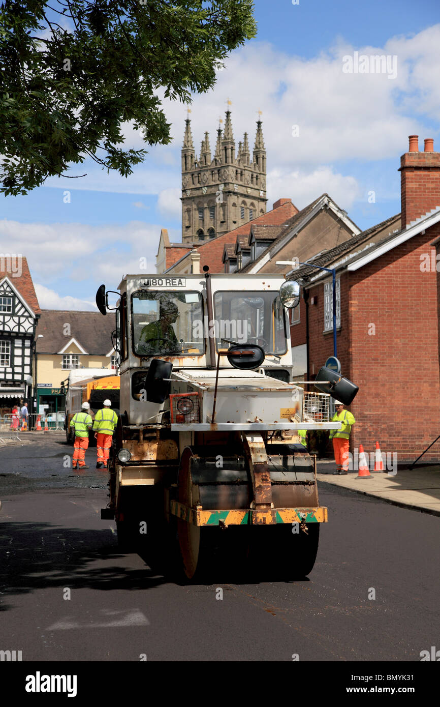 Un rouleau compresseur la préparation de la surface pour une pose d'asphalte maching dans Brook Street, Warwick Banque D'Images