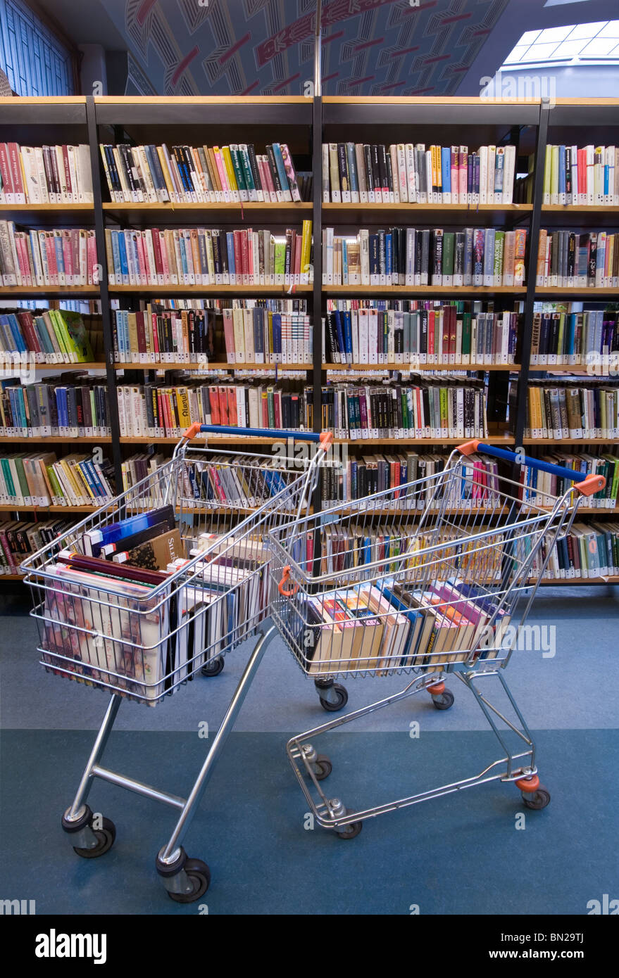 Livres dans un panier dans une bibliothèque Photo Stock - Alamy