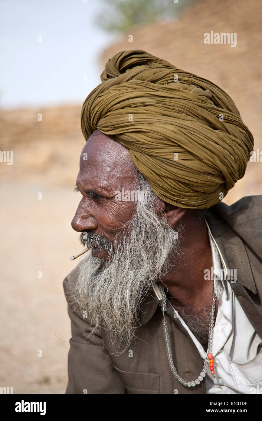 Old Indian man smoking a cigarette indienne (biri). Jaisalmer. Le Rajasthan. L'Inde Banque D'Images