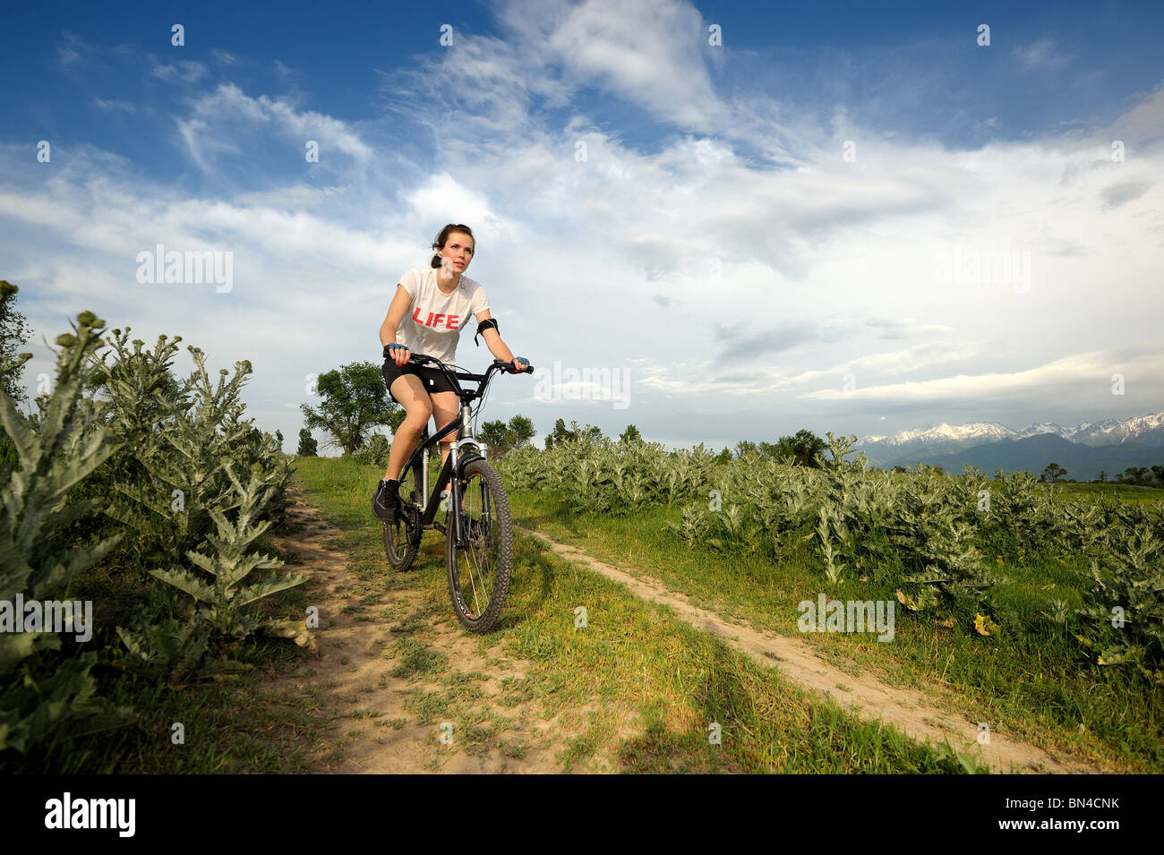 Girl riding a bike outdoor. Banque D'Images