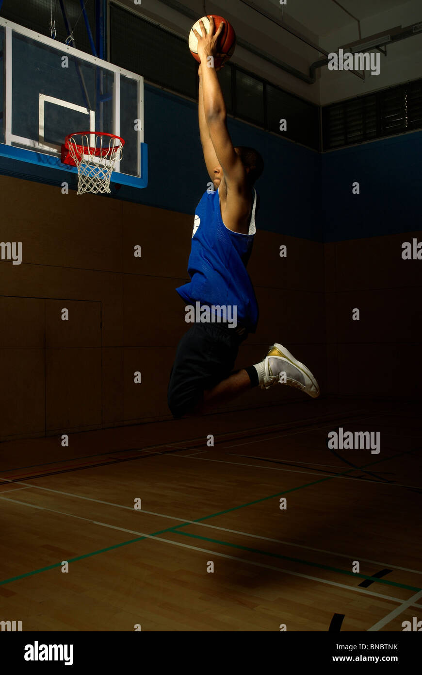 Basket-ball player jumping de hoop Banque D'Images
