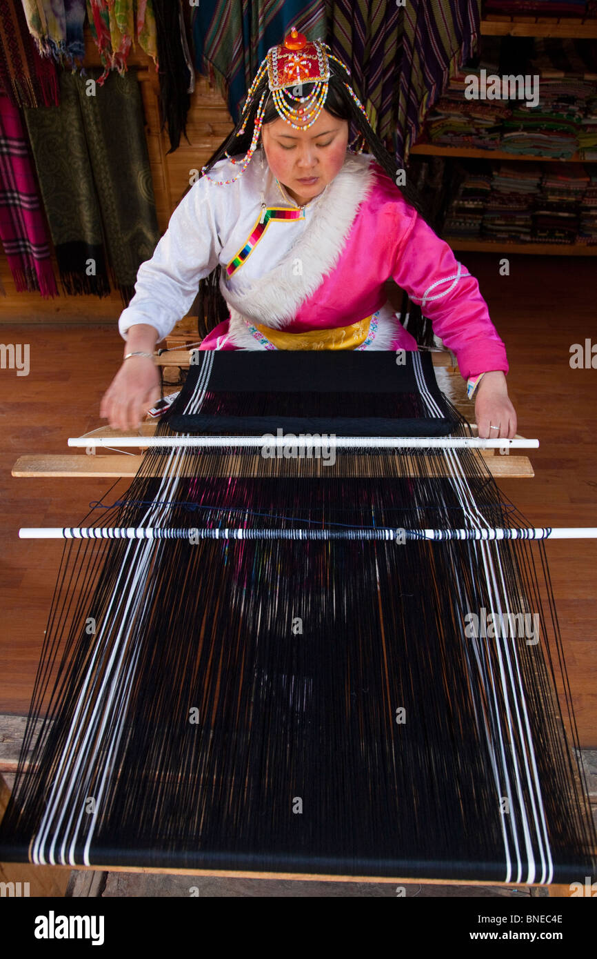 Femme minoritaire en tissage ou Shangri-La Zhongdian dans la province du Yunnan, Chine Banque D'Images