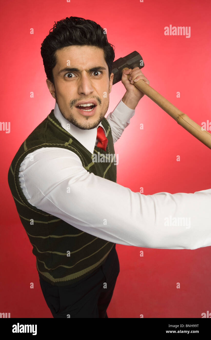 Portrait of a businessman holding a sledgehammer Banque D'Images