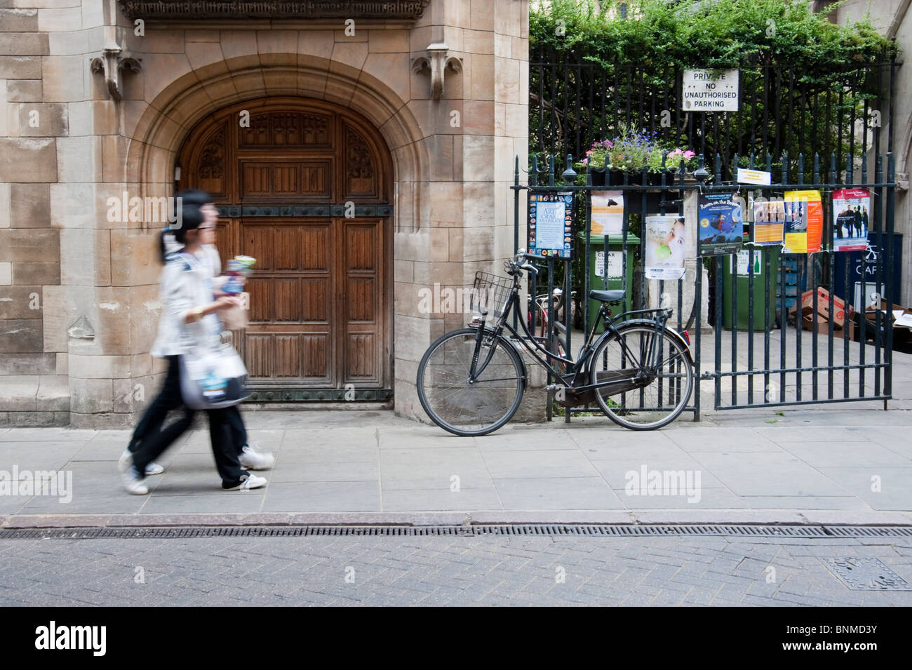 Les touristes japonais se balade le long de la Trinity Street Cambridge. Vitesse d'obturation lente pour donner un léger effet de flou. Banque D'Images