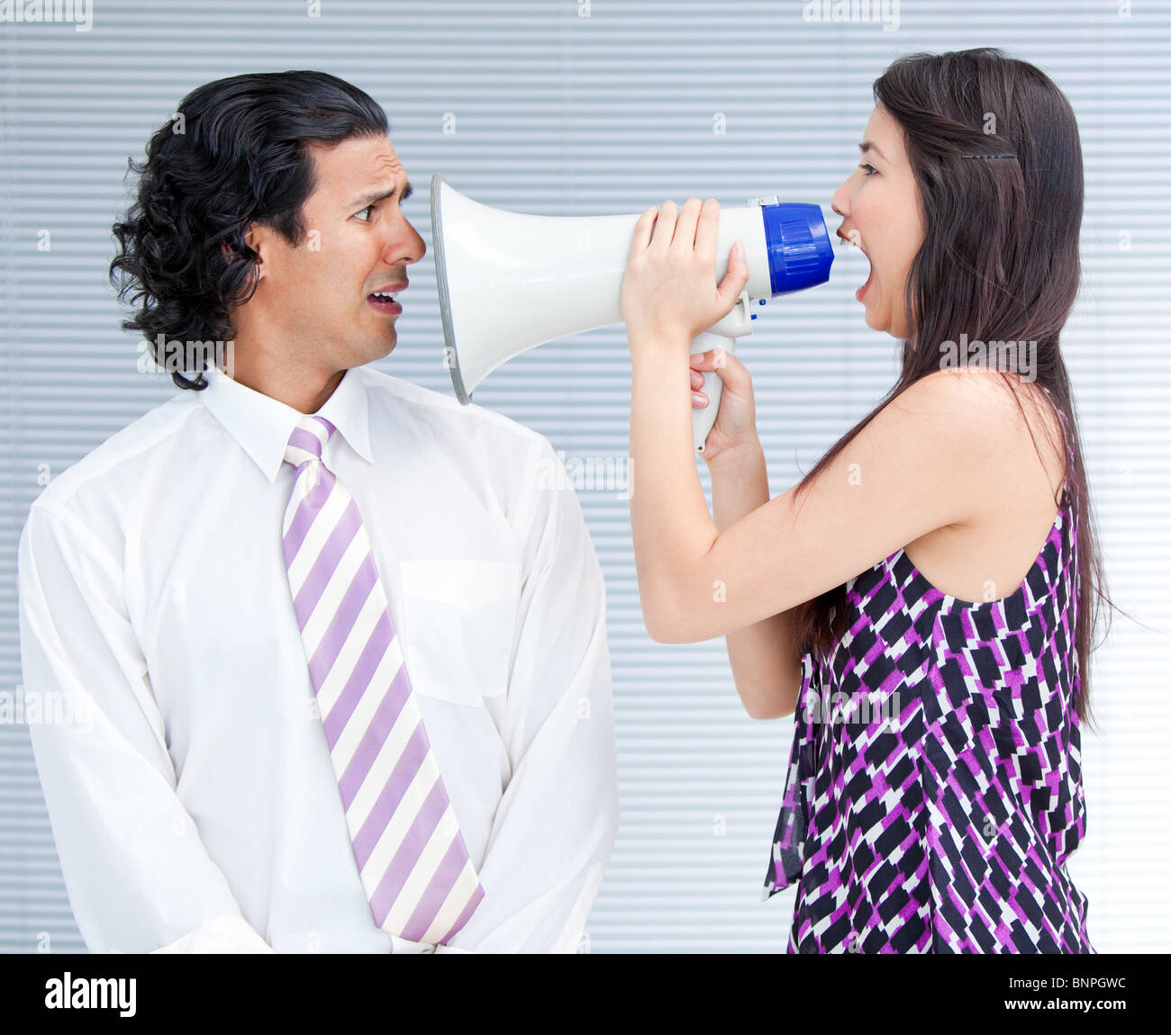 Furious businesswoman yelling through a megaphone Banque D'Images