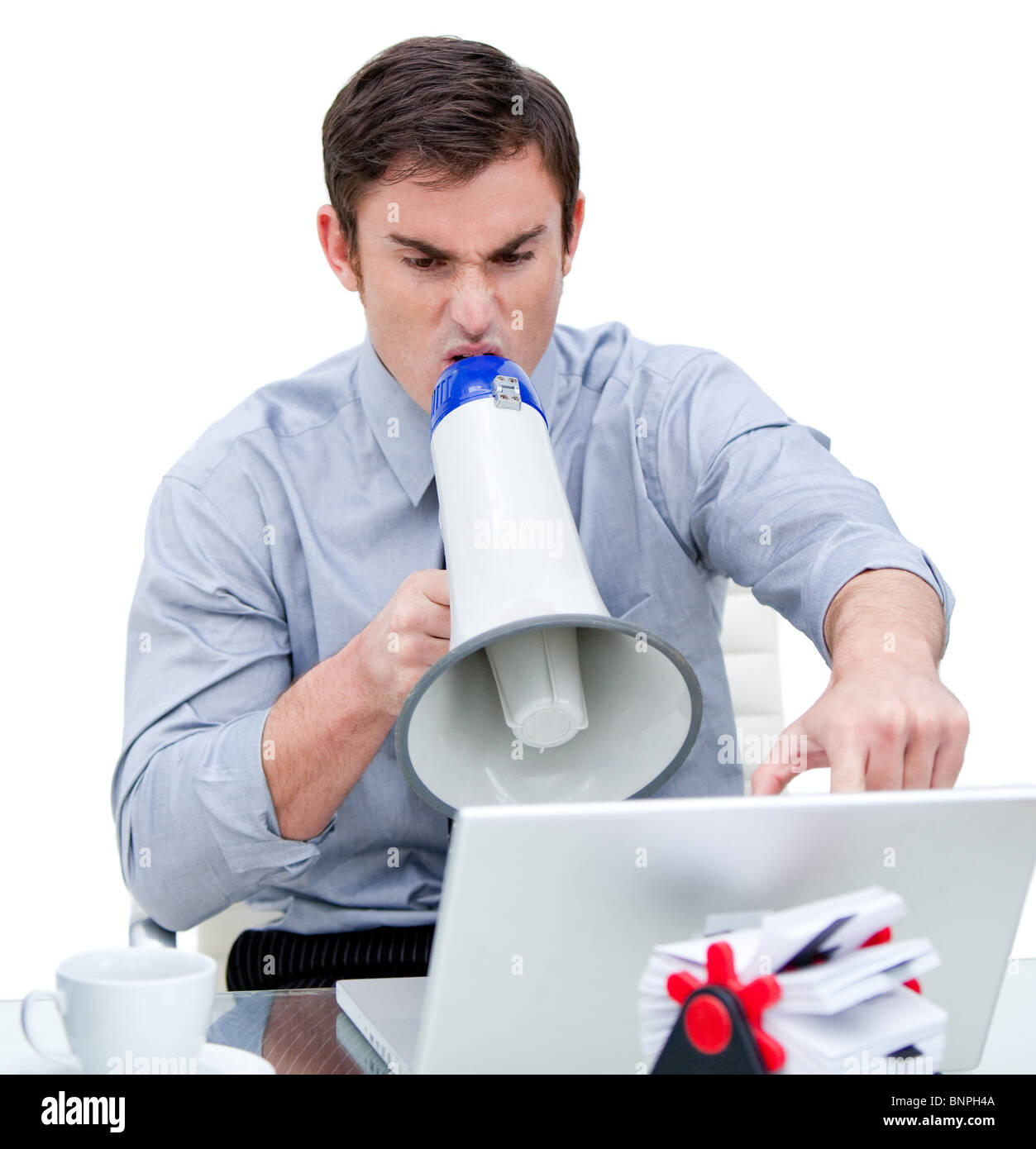 Angry businessman yelling through a megaphone Banque D'Images