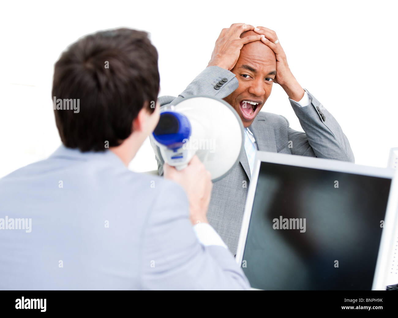 Businessman yelling through a megaphone Banque D'Images