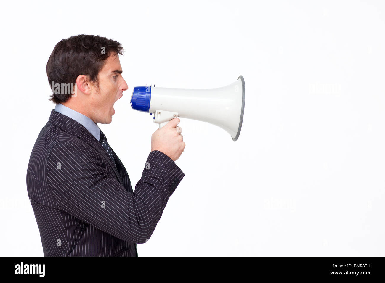 Profil d'un businessman shouting through a megaphone Banque D'Images