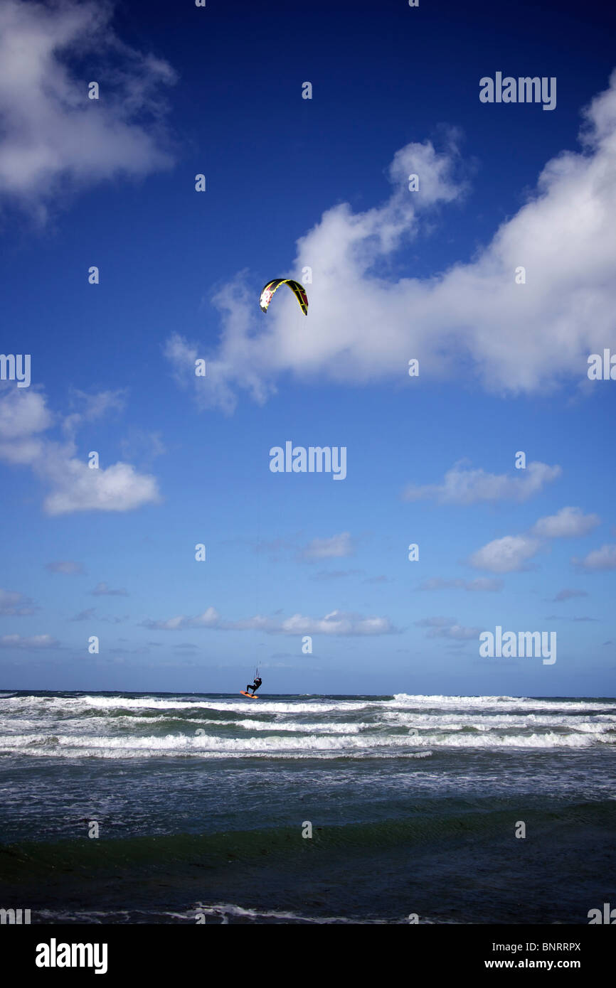 Sur les terres d'hommes kitesurfer dans l'eau juste après un saut sur son conseil. Banque D'Images Sur les terres d'hommes kitesurfer dans l'eau juste après un saut sur son conseil. Banque D'Images