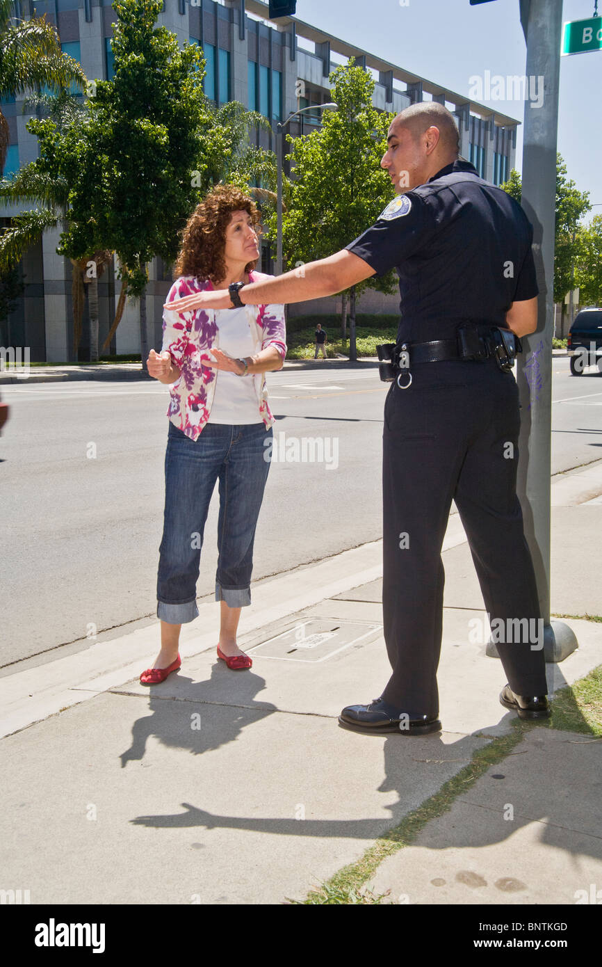 Une femme affirme avec un portrait policier après avoir été arrêté pour une infraction aux règlements de la circulation à Santa Ana, CA. Banque D'Images