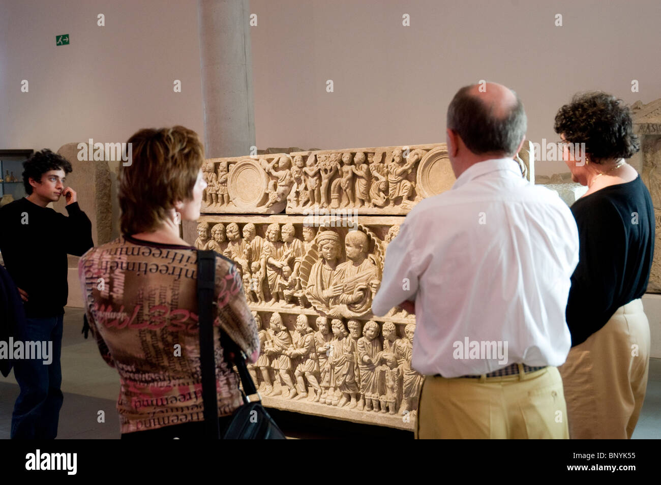 Touristes en groupe visitant le Musée archéologique d'Arles, Guide touristique expliquant les objets anciens exposés, coffret funéraire, vacances historiques, art de la civilisation antique Banque D'Images