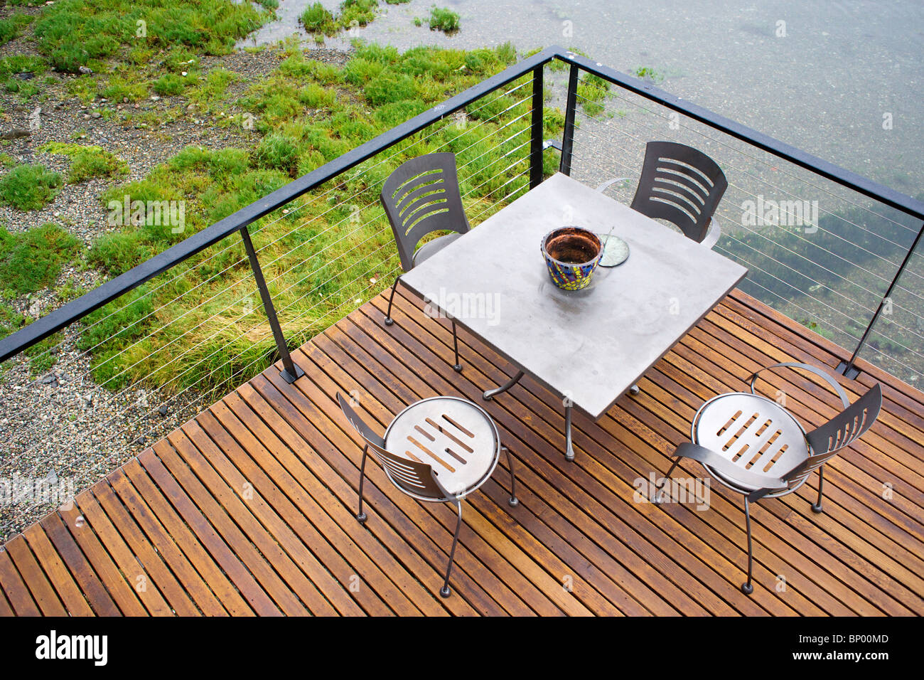 Table et chaises sur une terrasse en bois sur l'eau Banque D'Images