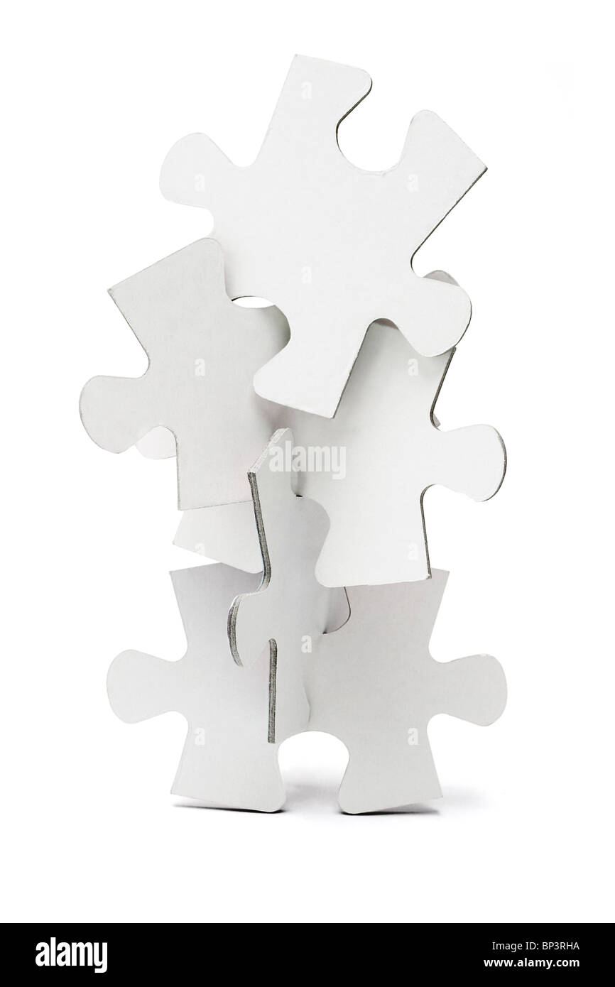 Pièces de puzzles denteux disposés pour former une tour verticale Banque D'Images