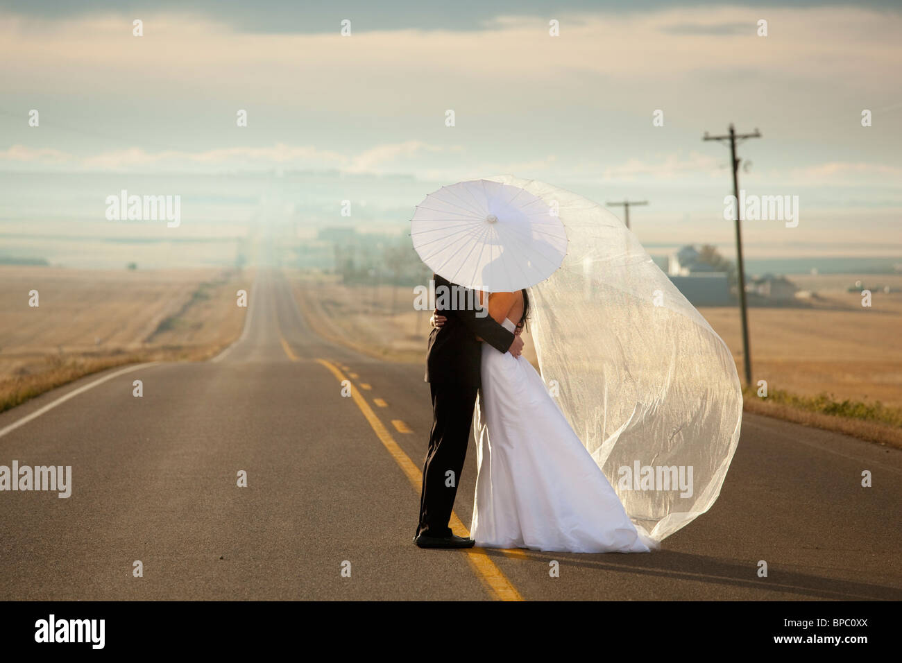 Three Hills, Alberta, canada ; mariés dans une étreinte debout sur une route dans les régions rurales de l'Alberta Banque D'Images