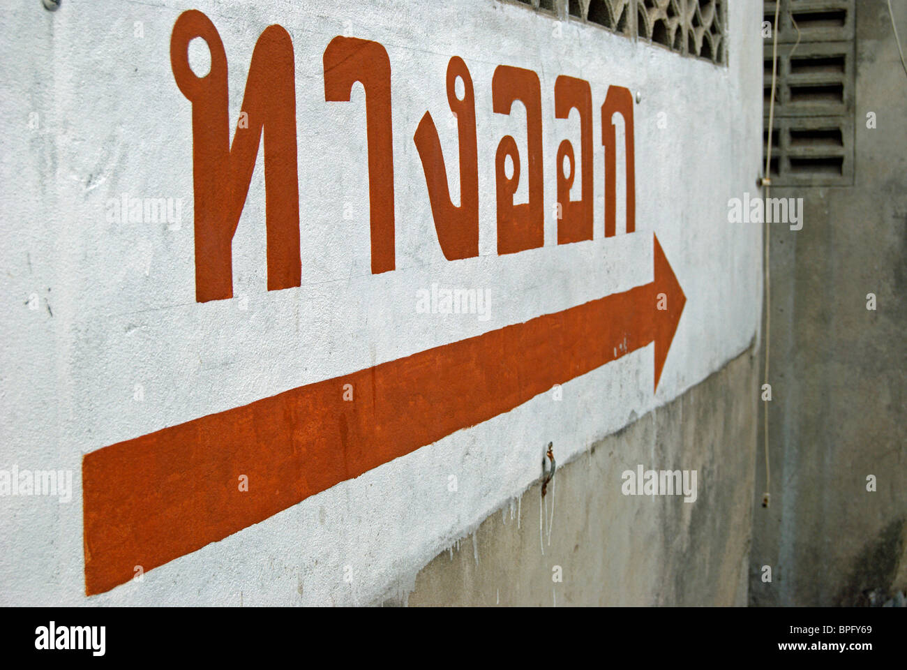 Signe de langue thaï dans un parking à phetchabun, Thaïlande, Asie du Sud-Est, en indiquant "issue" Banque D'Images
