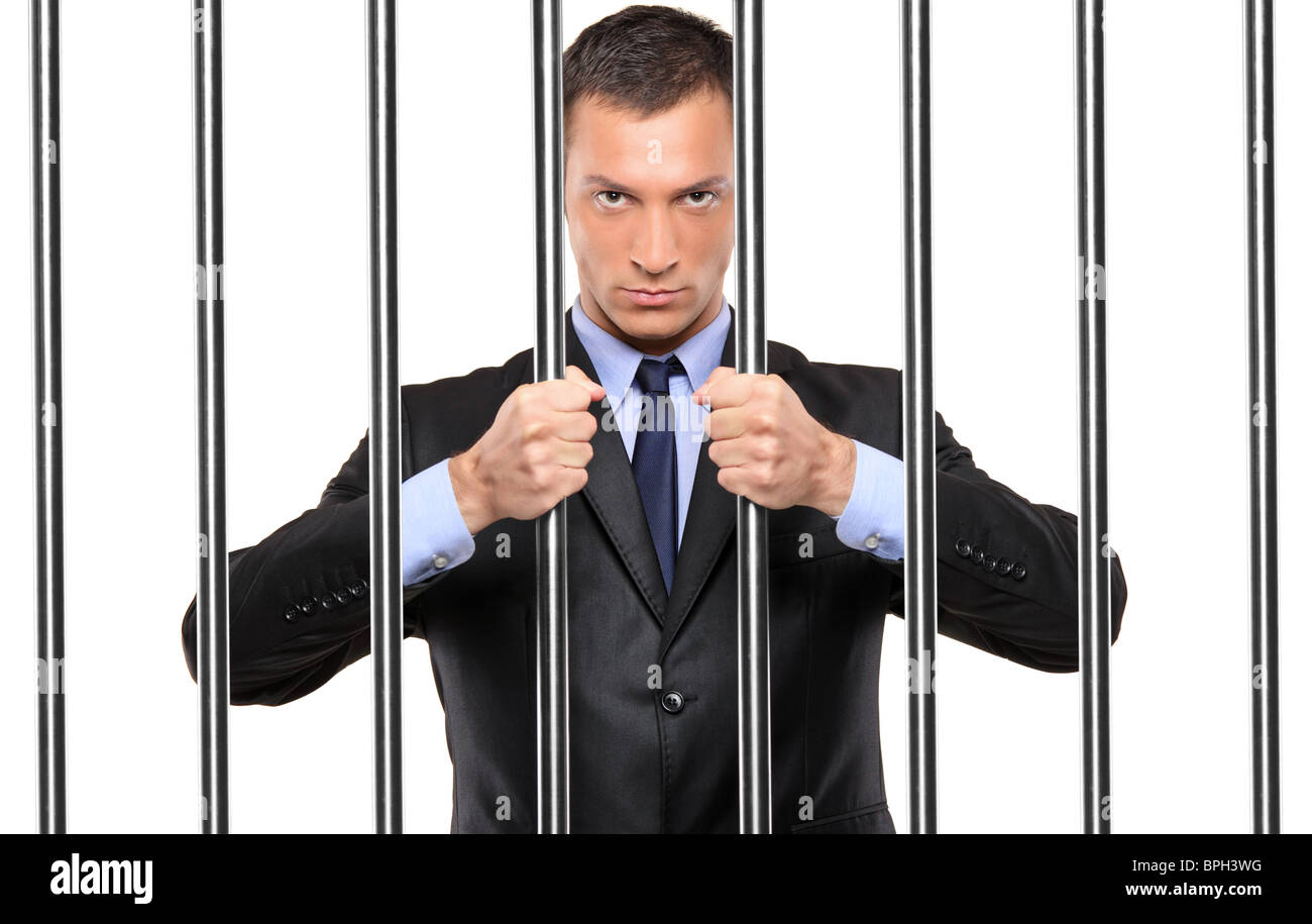 Un homme en prison bars holding Banque D'Images