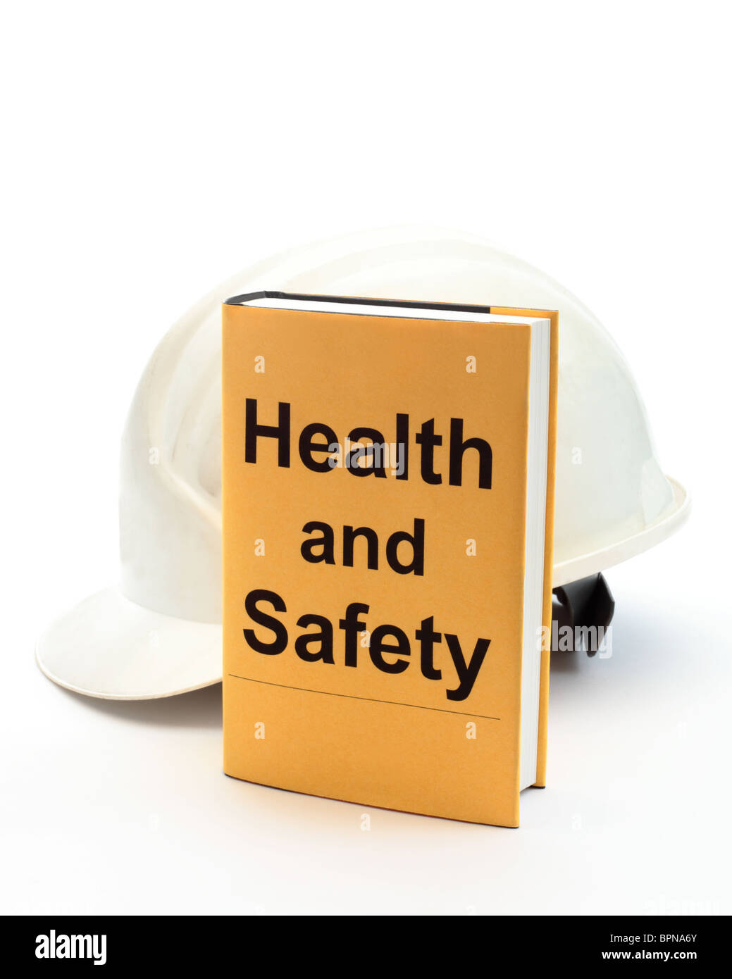 Réservez avec les mots "Santé et sécurité" sur le couvercle avec casque de sécurité derrière Banque D'Images