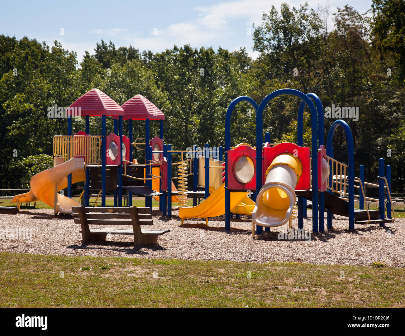 Aire de jeux pour enfants moderne dans parc verdoyant avec des diapositives et des portiques Banque D'Images