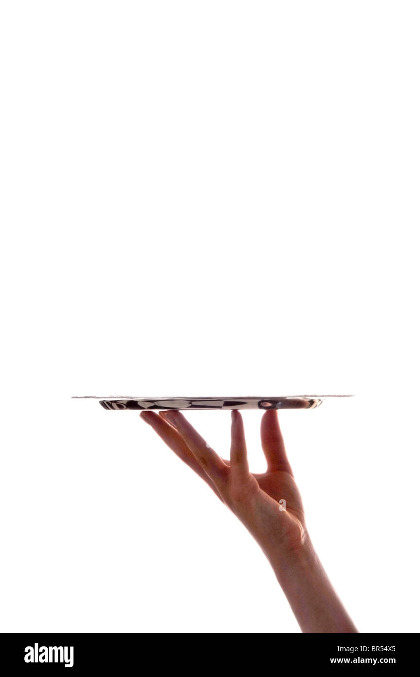 Hand holding silver tray on white Banque D'Images