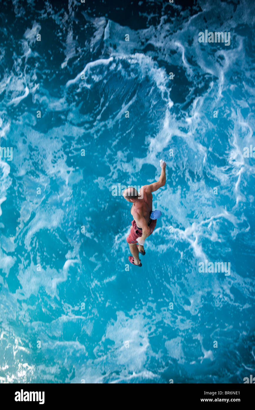 Un male rock climber tombe alors que l'escalade / deep water solo à Majorque en Espagne. Banque D'Images