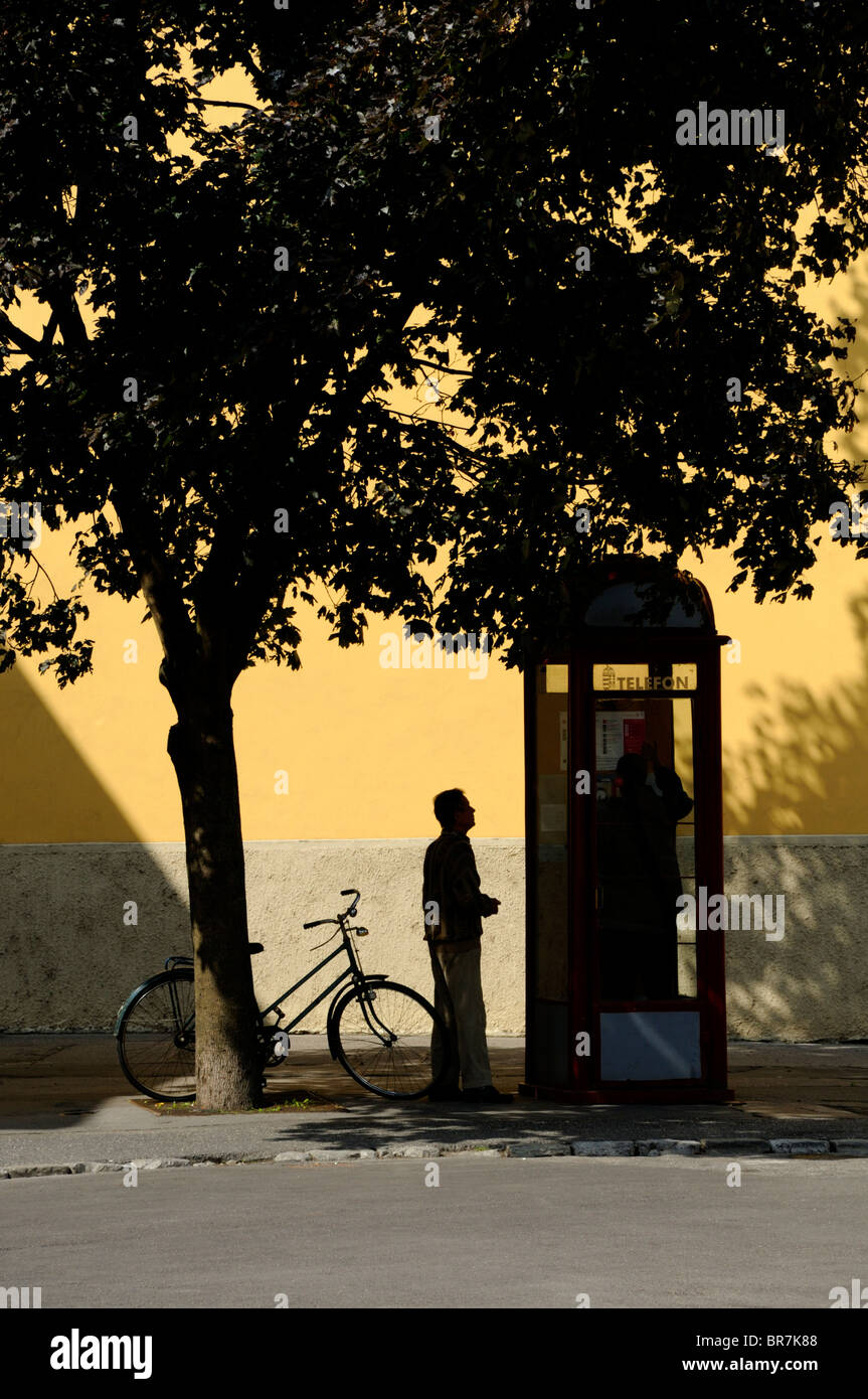 Gyor, Hongrie, Transdanubia W.Location, d'attente, l'homme fort par le téléphone de l'église des Carmélites jaune Banque D'Images