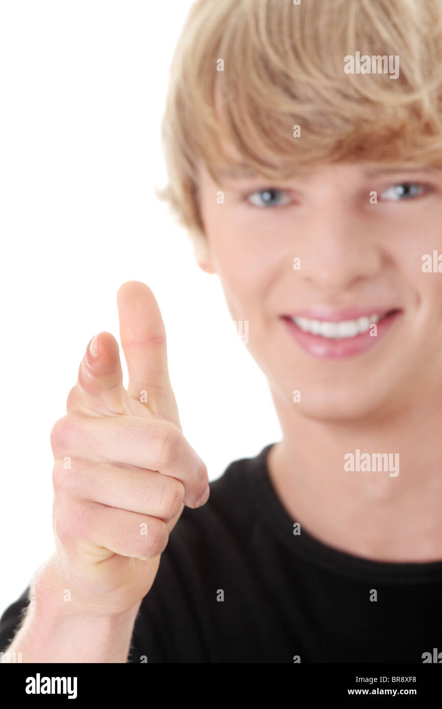 Portrait of a young man smiling, sur vous. Isolé sur blanc. Focus on hand Banque D'Images