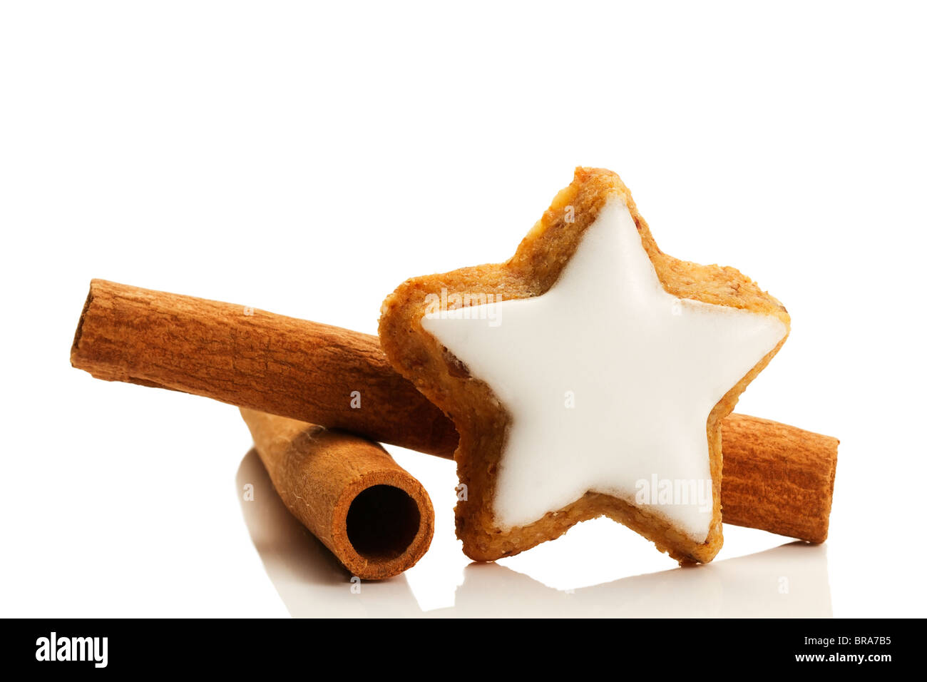 Biscuit à la cannelle en forme d'étoile et des bâtons de cannelle sur fond blanc Banque D'Images