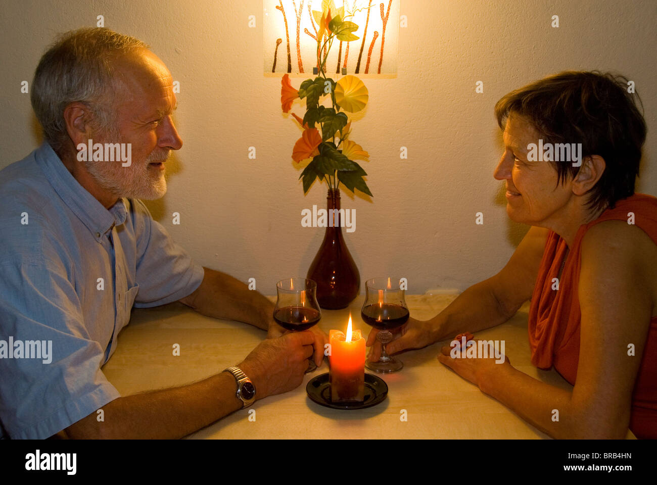 Couple de personnes âgées avec un verre de vin à la chandelle Banque D'Images