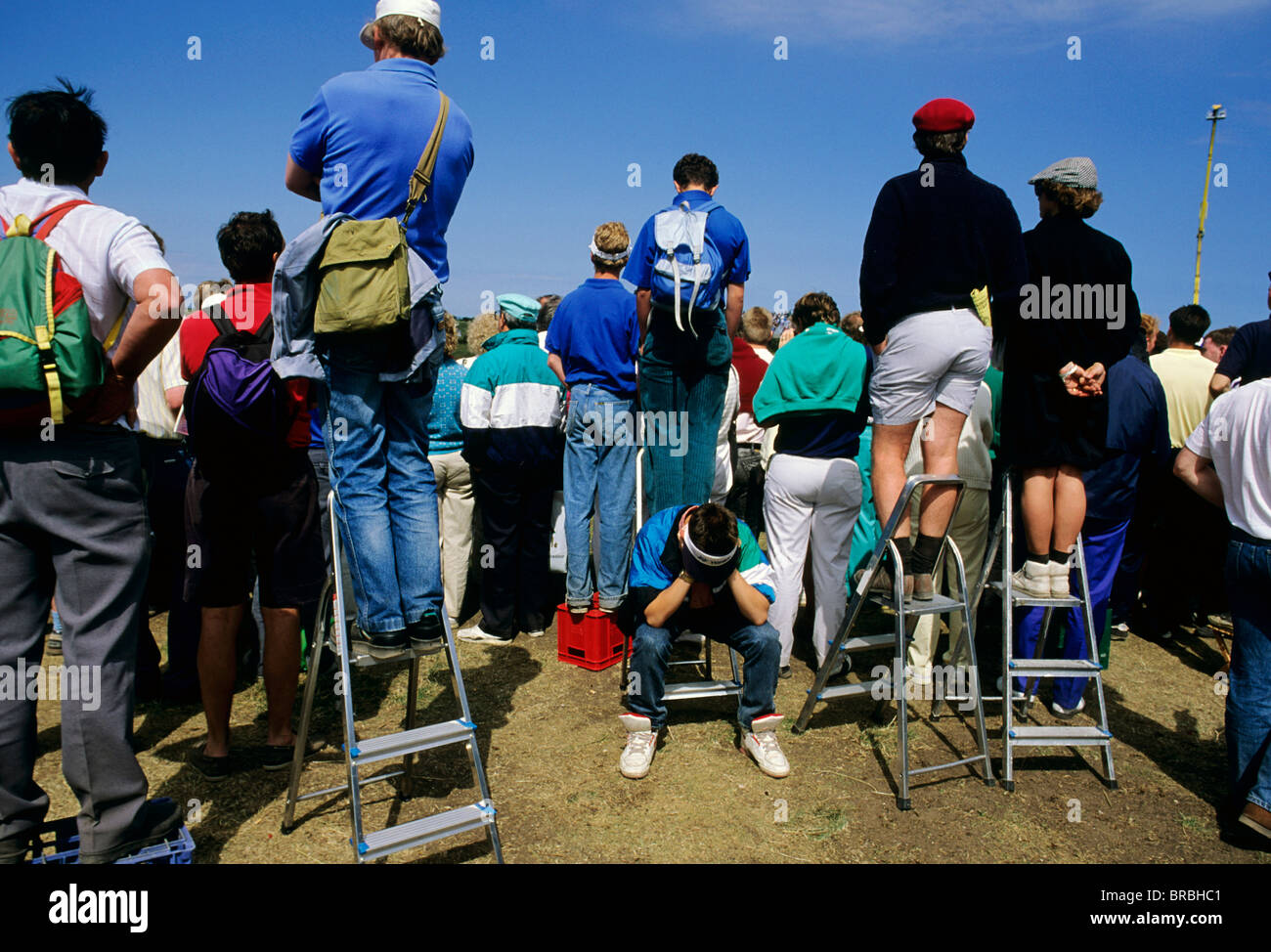 Les spectateurs à prendre des mesures à court de voir des golfeurs sur le green Banque D'Images