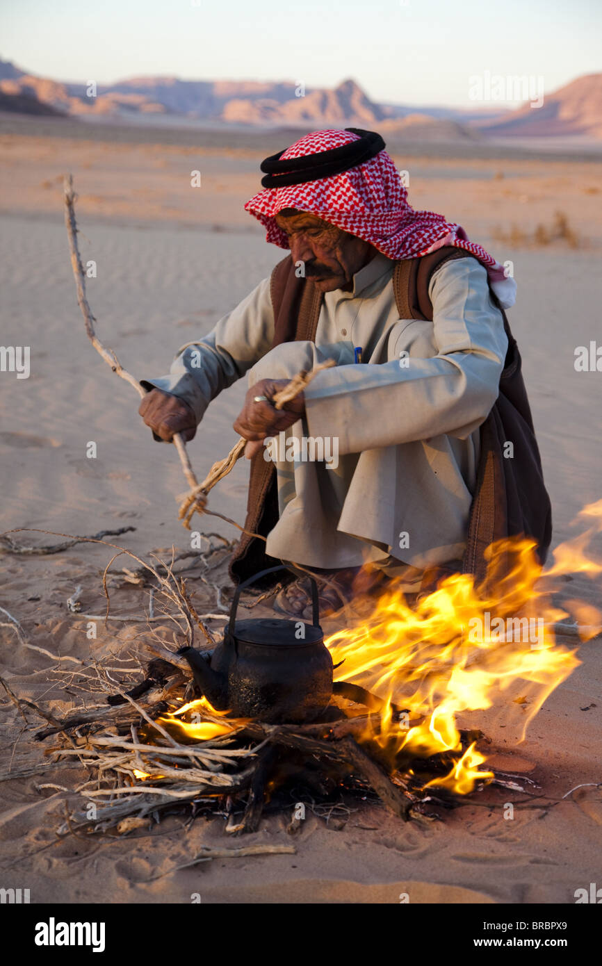 Faire du thé bédouin sur feu ouvert dans le désert de Wadi Rum, Jordanie Banque D'Images