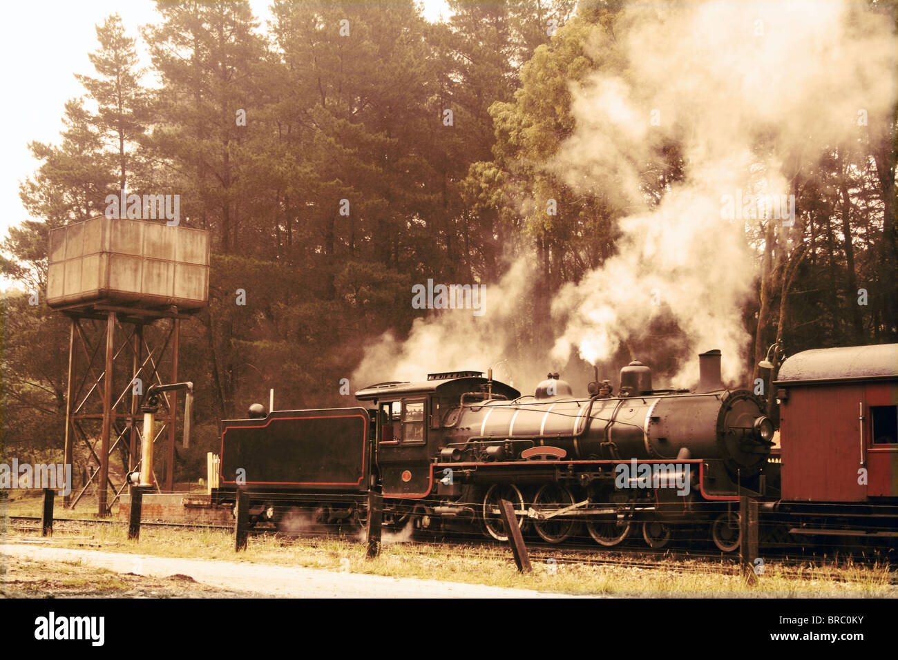 Train à vapeur au départ en couleurs sépia Banque D'Images