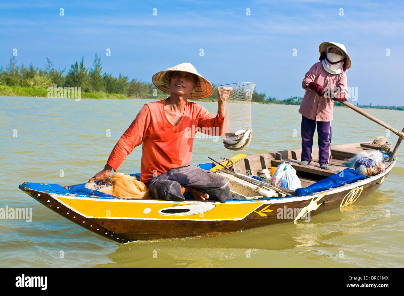 Habillé traditionnellement les femmes Vietnamiennes pêche, Hoi An, Vietnam, Indochine Banque D'Images