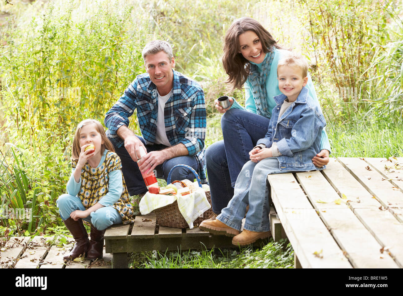 Les parents et les enfants ayant de pique-niquer dans la campagne Banque D'Images