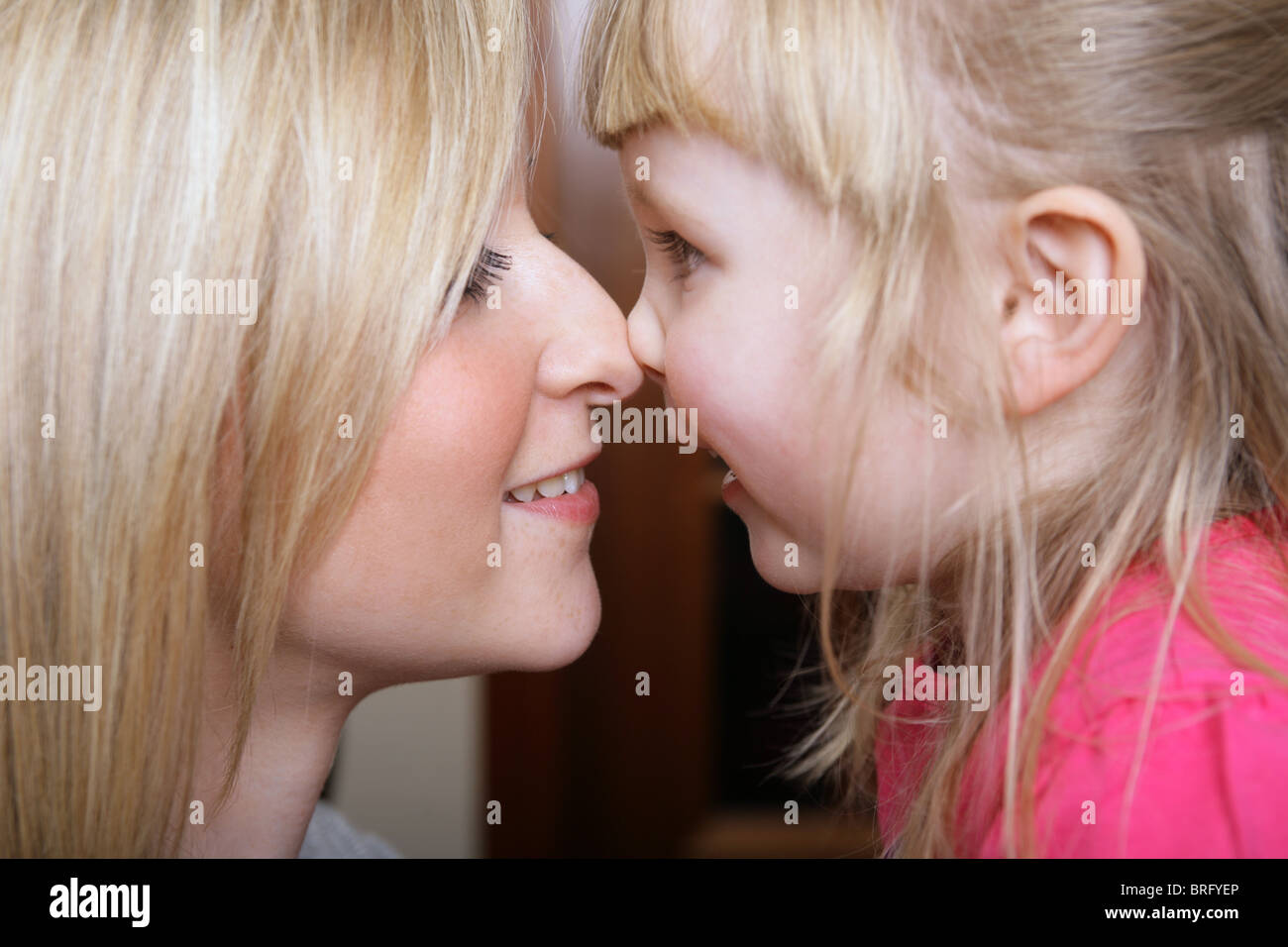 Deux soeurs face à face de toucher leurs nez. Banque D'Images