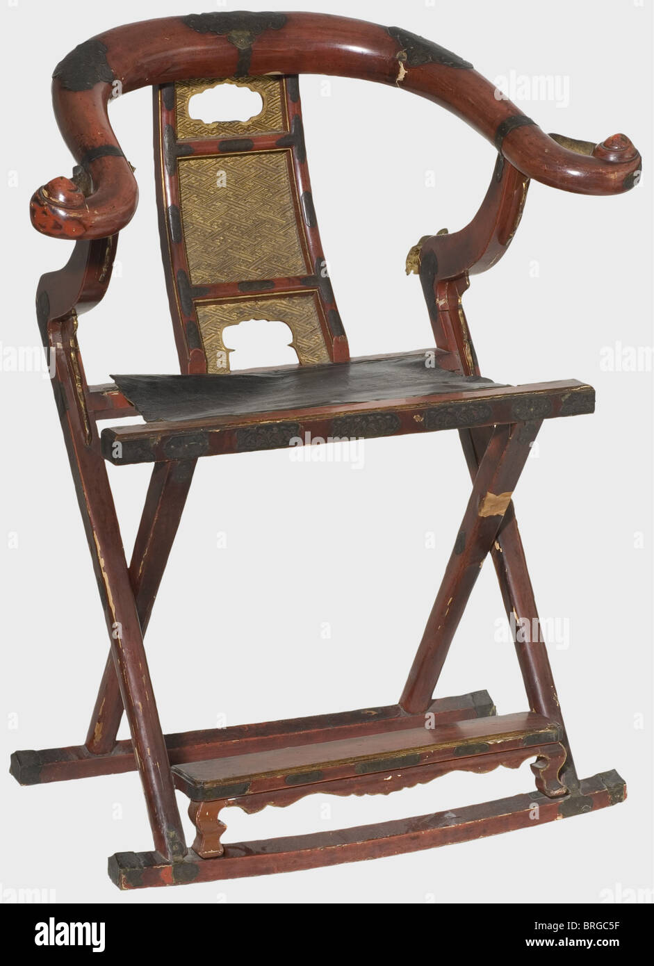 Une chaise pliante japonaise (kyokuroku), bois laqué rouge du XIXe siècle,  dossier doré sculpté avec des motifs swastika, siège en cuir noir,  garnitures en laiton gravées. Imperfections et dommages nécessitant une  restauration.