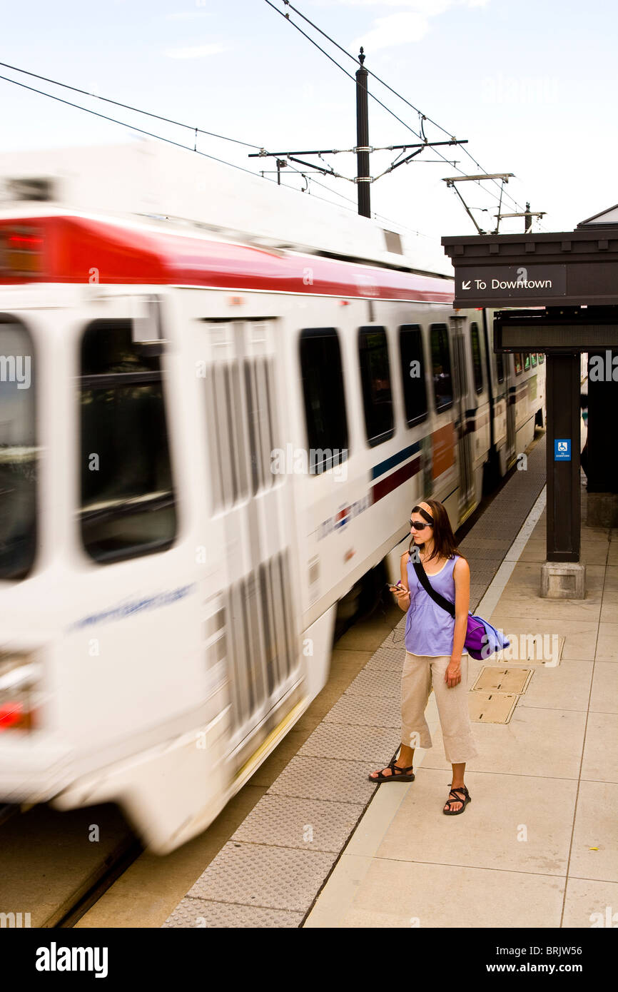 Une jeune femme écoute ses MP3 player en attendant son train à Salt Lake City, Utah. Banque D'Images