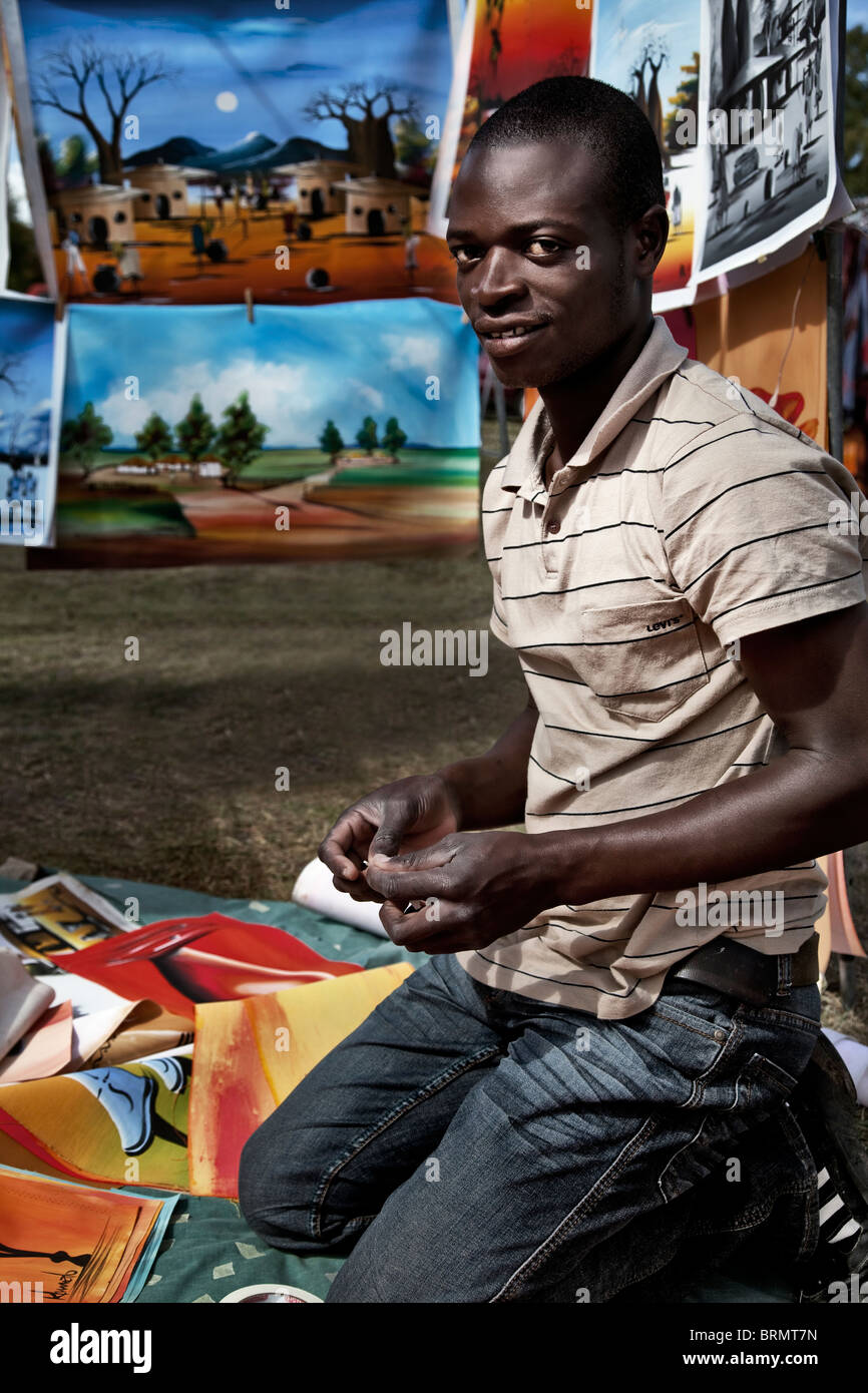 Jeune homme africain agenouillée à décrochage art Banque D'Images