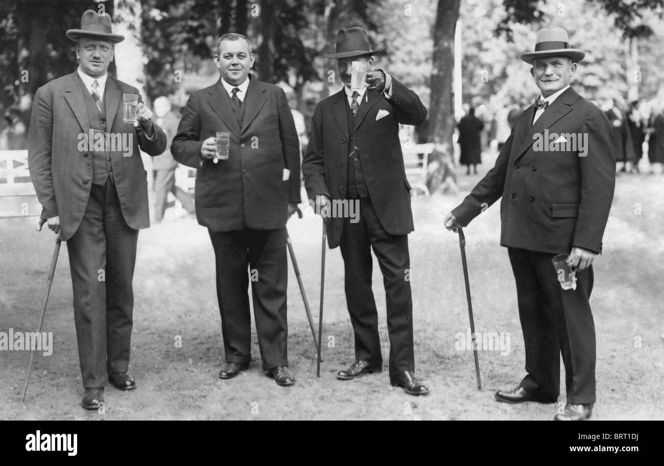 Quatre hommes avec des verres de bière et cannes, photographie historique, autour de 1922 Banque D'Images
