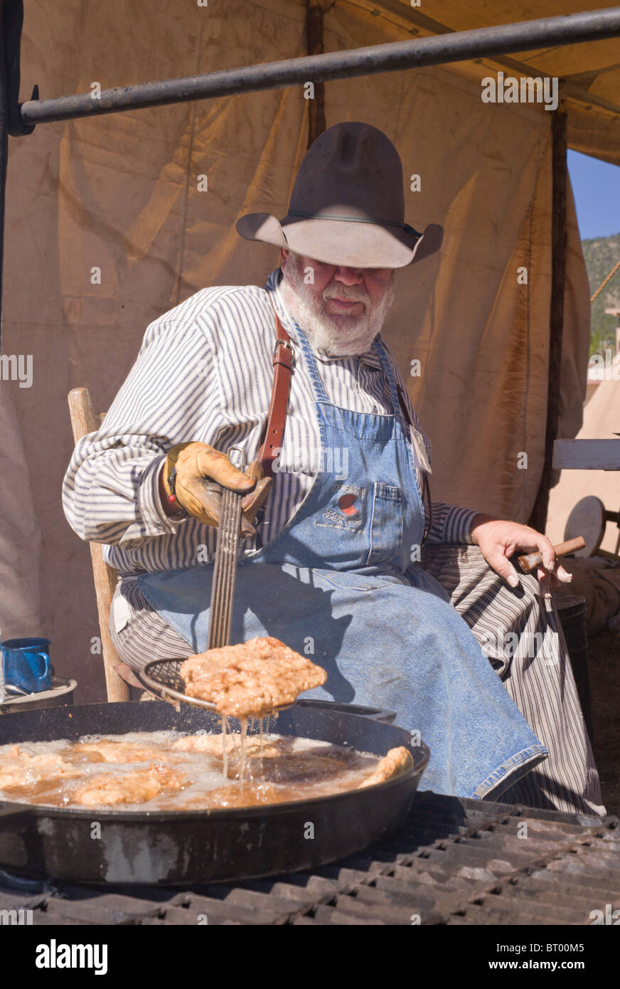 Un fumeur de cigare, à la cook cowboy Lincoln County Cowboy Symposium et Chuck Wagon Cook-Off, Ruidoso Downs, Nouveau Mexique. Banque D'Images