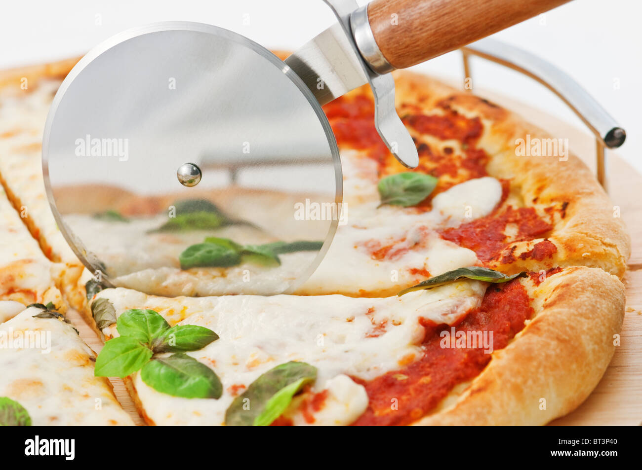 Pizza et cutter close up Banque D'Images